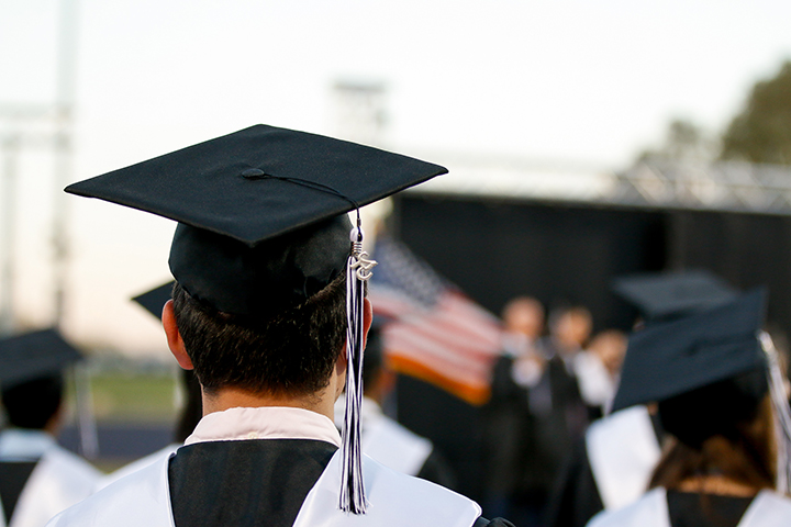 Closeup from behind of a graduate in his black cap