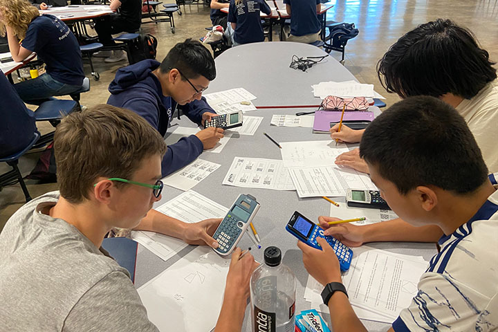 Students use calculators while working on math problems