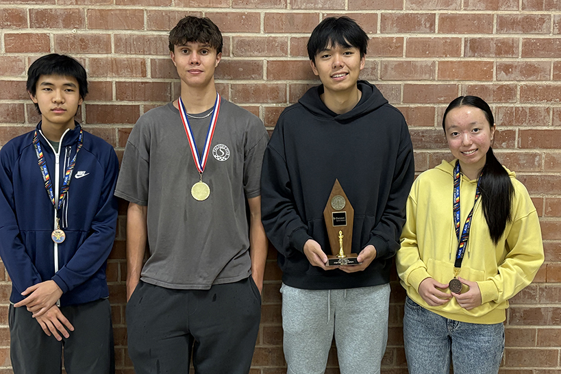 Three teen boys and a teen girl pose with their trophies