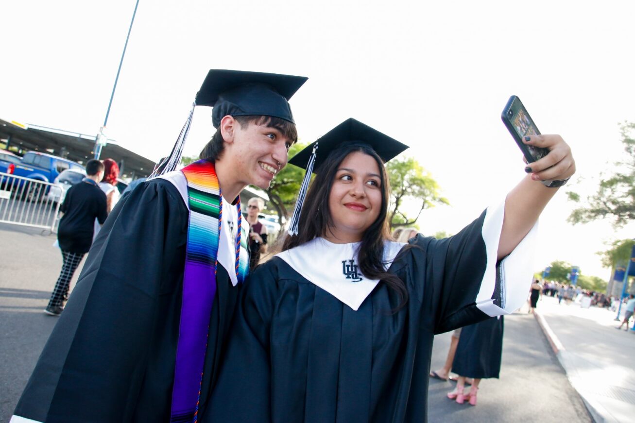 Two UHS grads take a selfie together before the ceremony